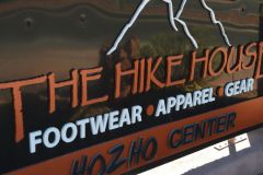 The Hike House sign hanging from post near Arabella Hotel Sedona in Sedona, AZ