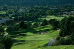 Golf course with greens with large amount of trees surrounding the perimeter near Arabella Hotel Sedona in Sedona, AZ