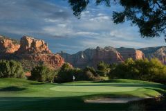 Golf course with greens and flag sticking out of greens with trees and mountains surrounding the perimeter near Arabella Hotel Sedona in Sedona, AZ