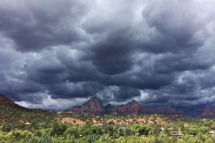 Gray skies over desert foliage with mountains in background near Arabella Hotel Sedona in Sedona, AZ