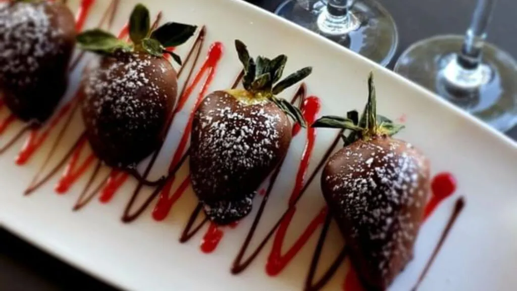 Strawberries dipped in chocolate with powdered sugar and syrups for the Arabella Sedona Romance Package.