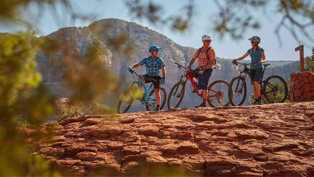 Three people riding bikes in the Sedona, AZ desert.